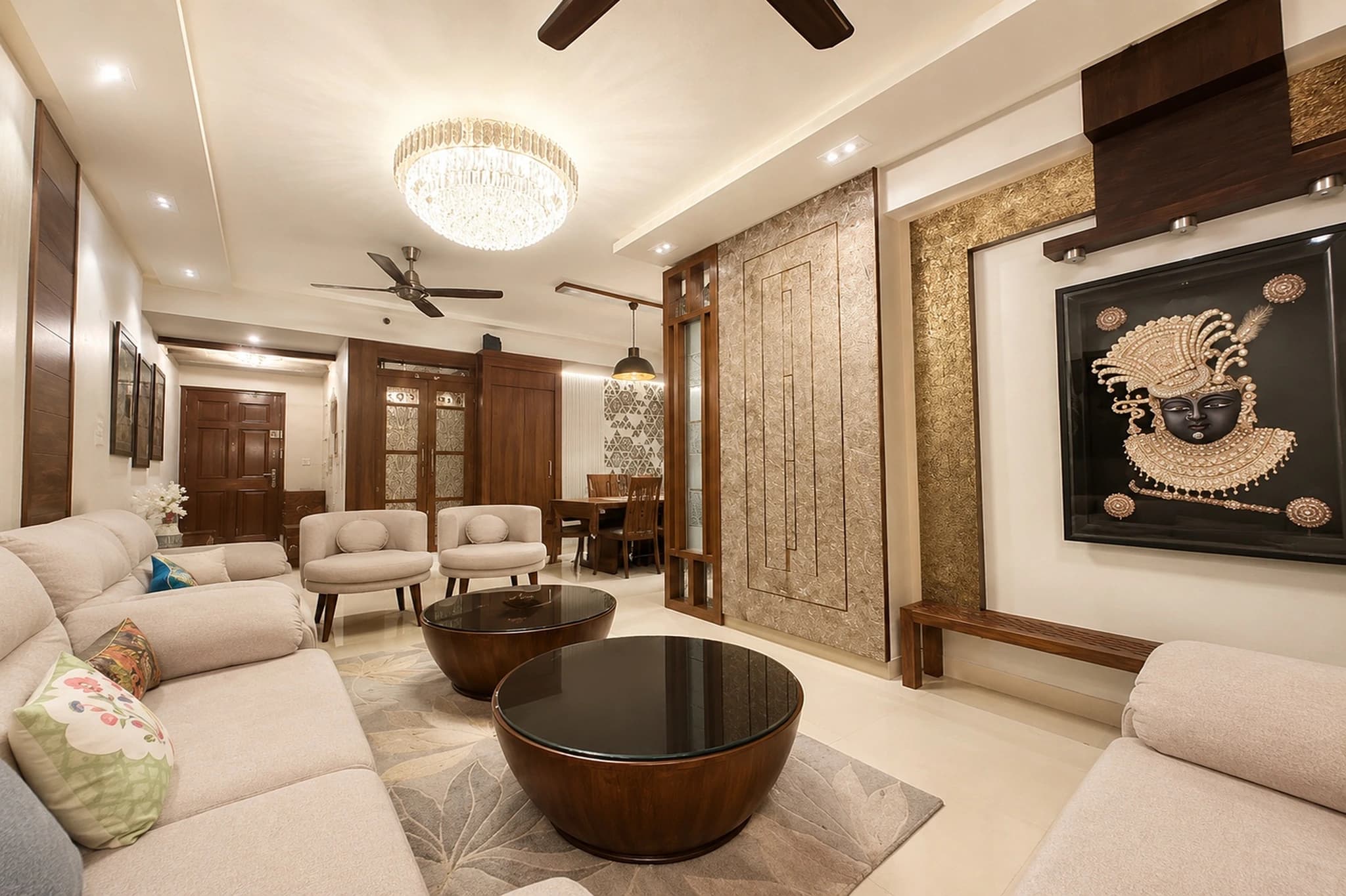 Luxury modern living room interior design featuring crystal chandelier, cream sectional sofa, and Pichwai artwork by IndecSpace