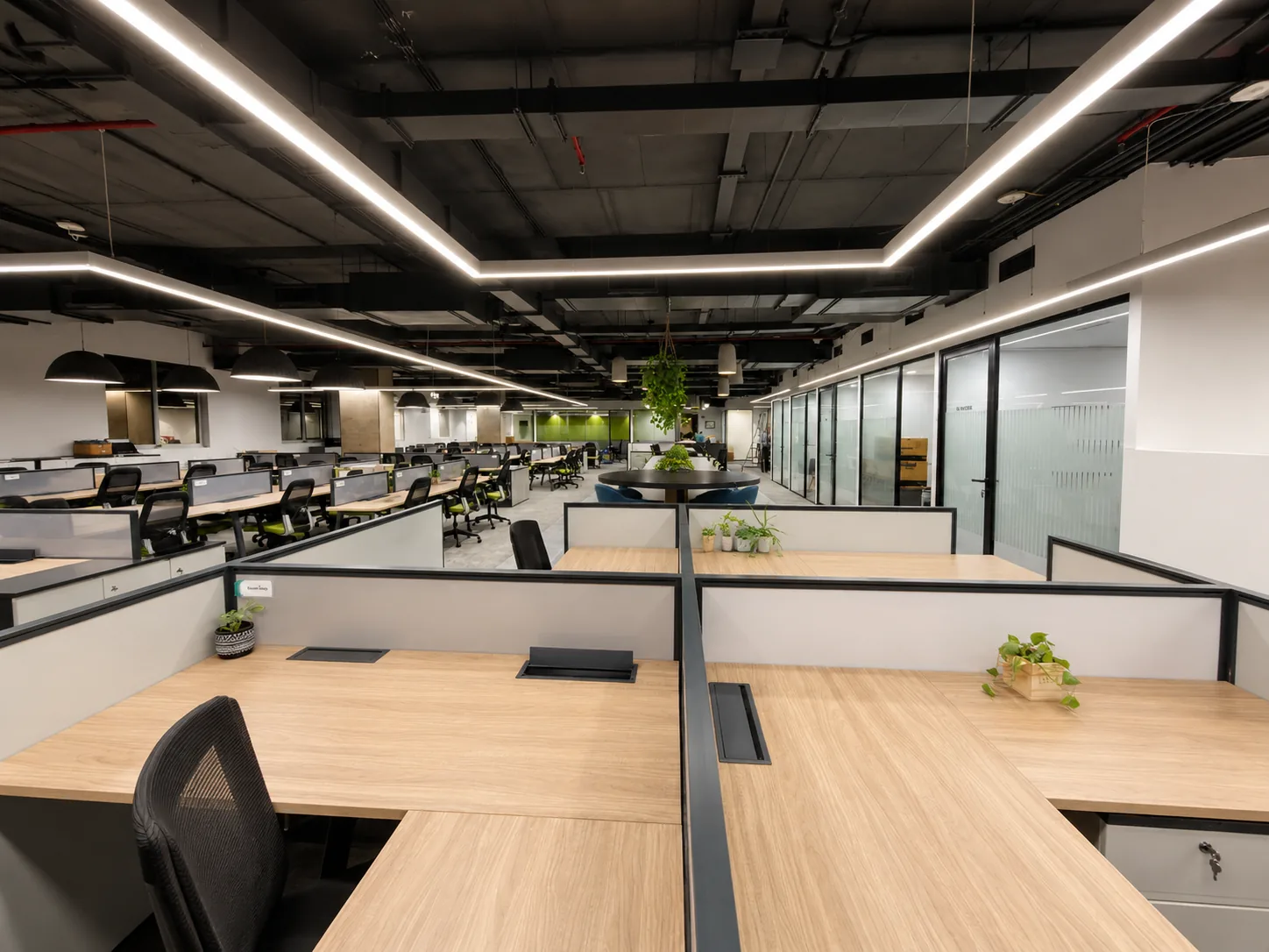 Open Plan Office Workstations with Linear Lighting by IndecSpace